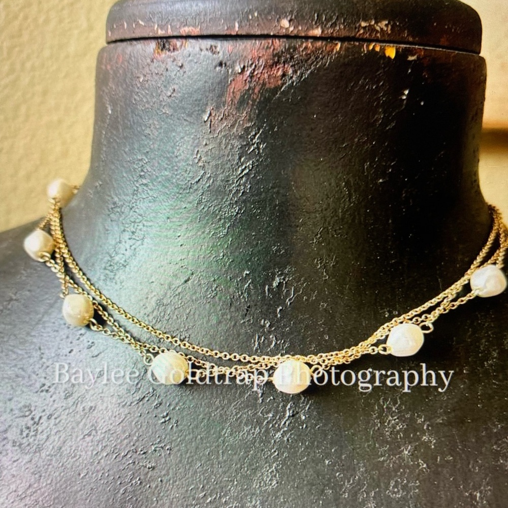 Gold-colored necklace with white beads
